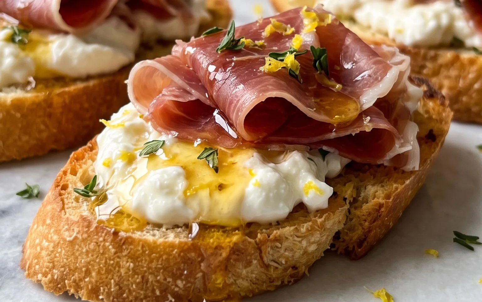 Beef Prosciutto Crostini with Burrata and Lemon Honey Drizzle