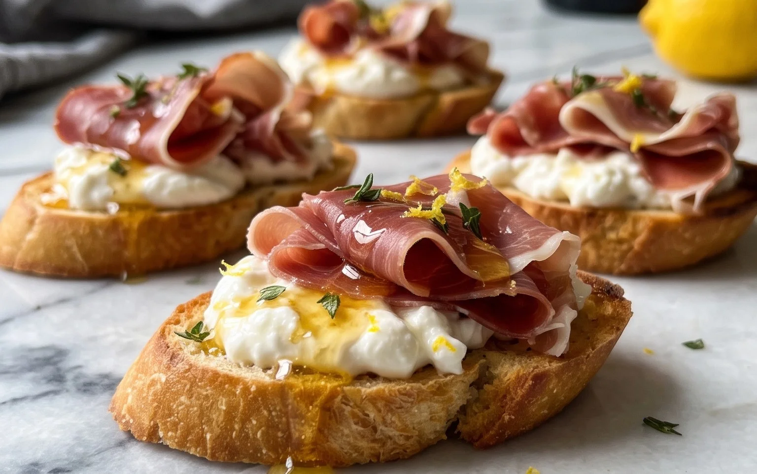 Beef Prosciutto Crostini with Burrata and Lemon Honey Drizzle